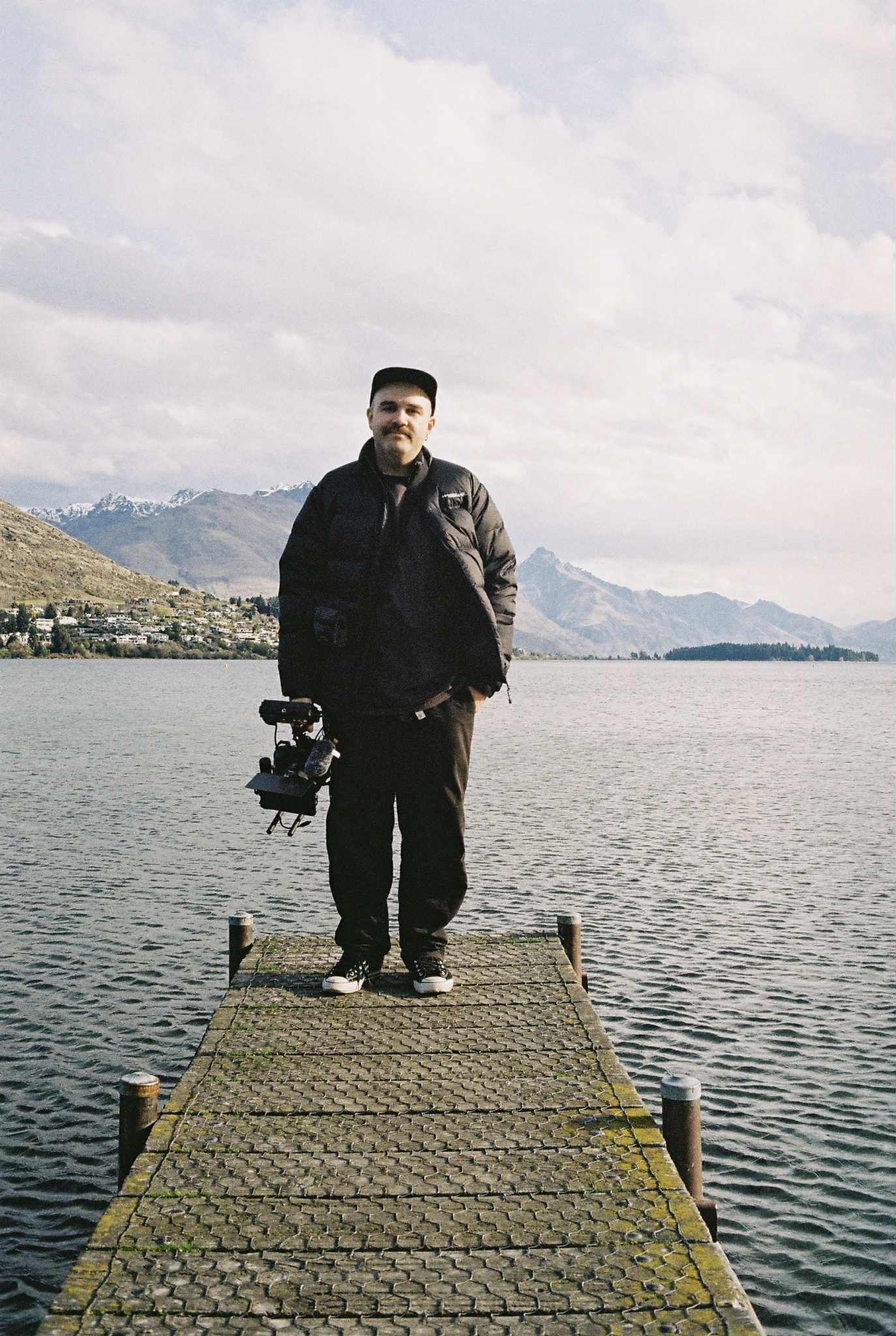 Guy - Music video workshop instructor holding camera by the lake
